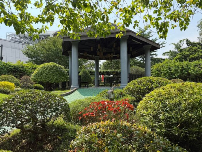 “The gazebo in the maze area, tucked behind sculpted shrubs and bright flowers, offers a place to rest and enjoy the view.”